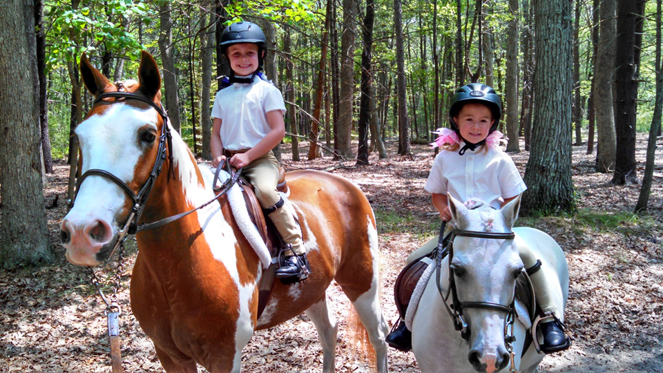 two kids on a horses