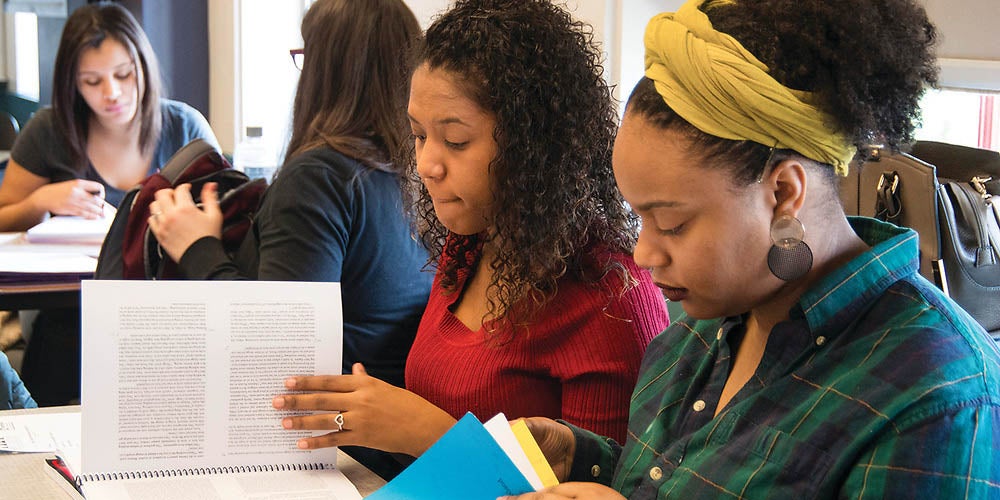 four URI students in classroom