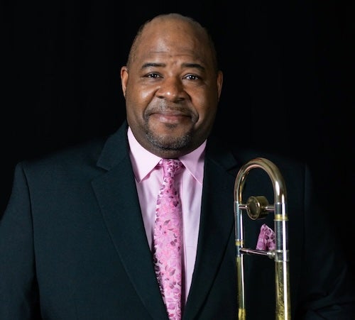 Dr. Emmett Goods is pictured with his trombone.