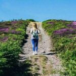 girl on a path halfway up a hill