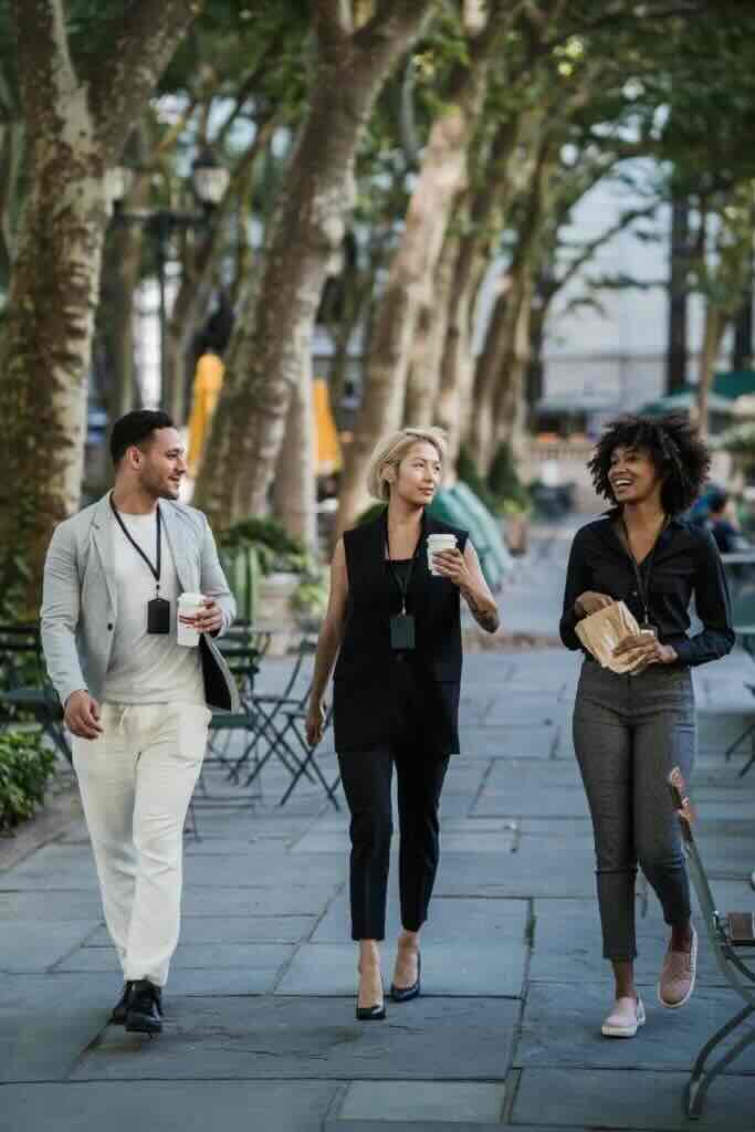 Adults walking together holding coffee cups and other snacks