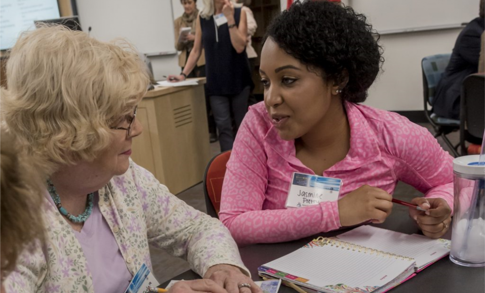 Students engage with community members at URI hackathon events.