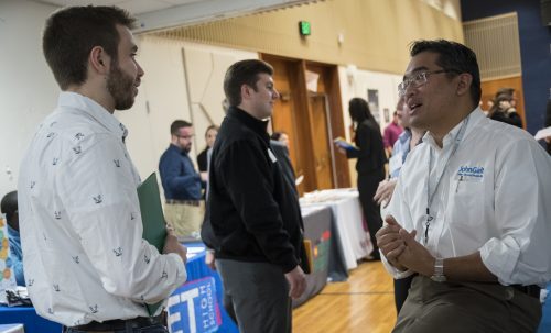 Students talk with corporate representatives at one of URI's many career events.