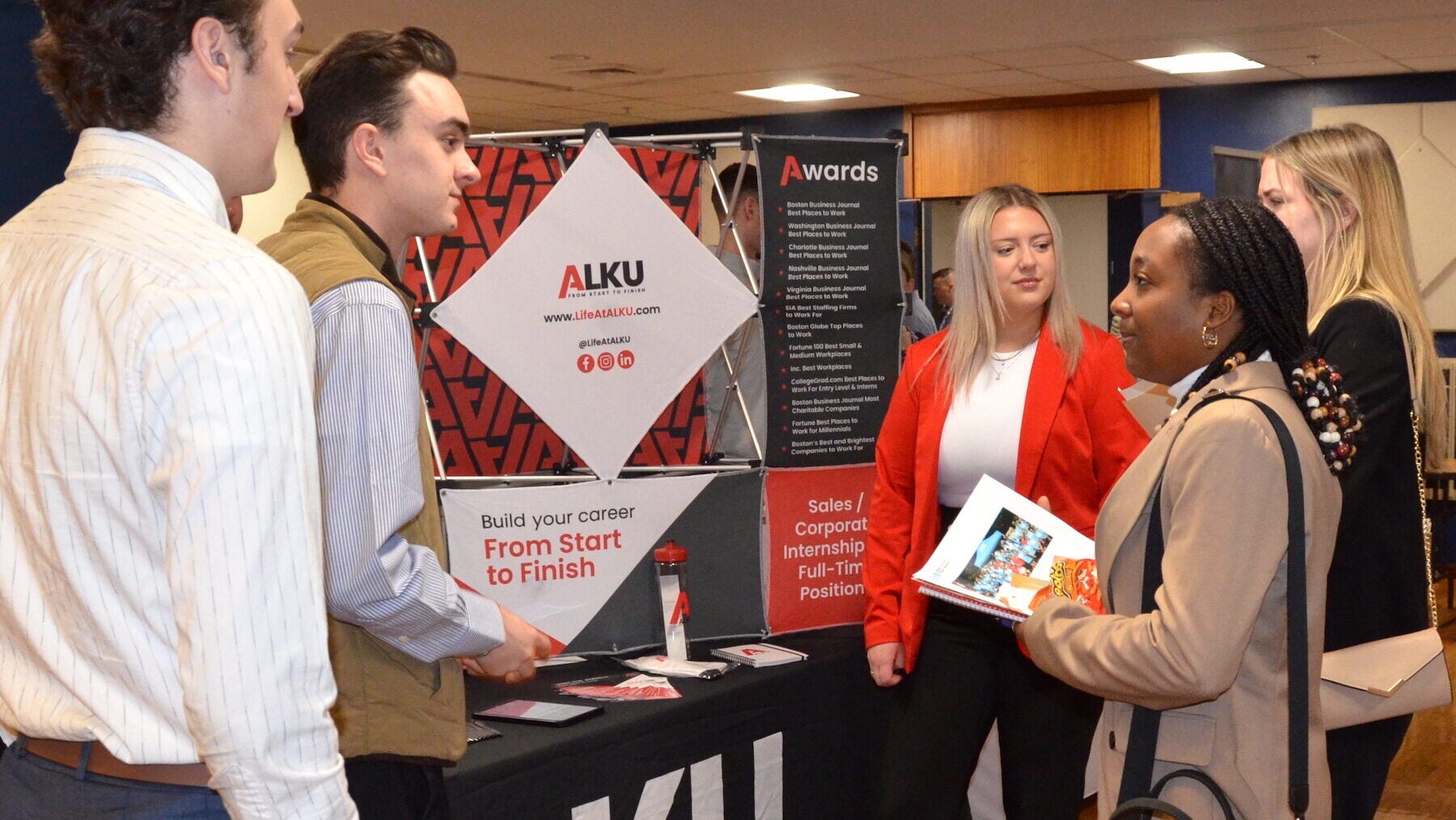 URI Business student at an ALKU information booth