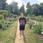 URI Supply Chain Management student standing in a garden