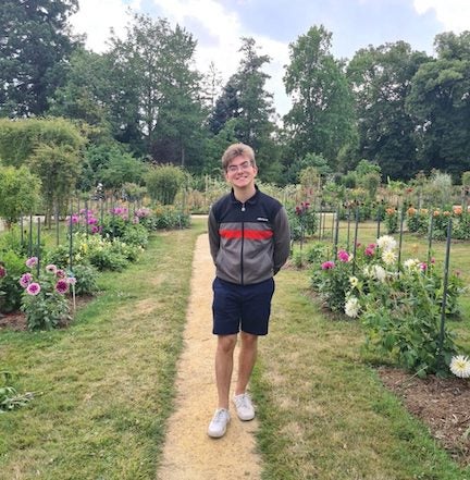 URI Supply Chain Management student standing in a garden