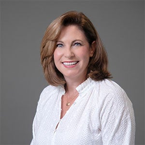 woman smiling wearing a white shirt