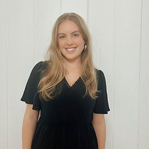 URI student smiling standing in front of a white background