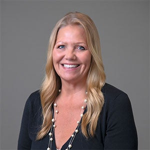 woman smiling wearing a dark blue shirt