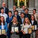 URI Student Athletes in a group holding awards
