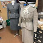 Two women’s suits – from the 1950s (left) and about 1947 – show the influence of the military on style of the time.