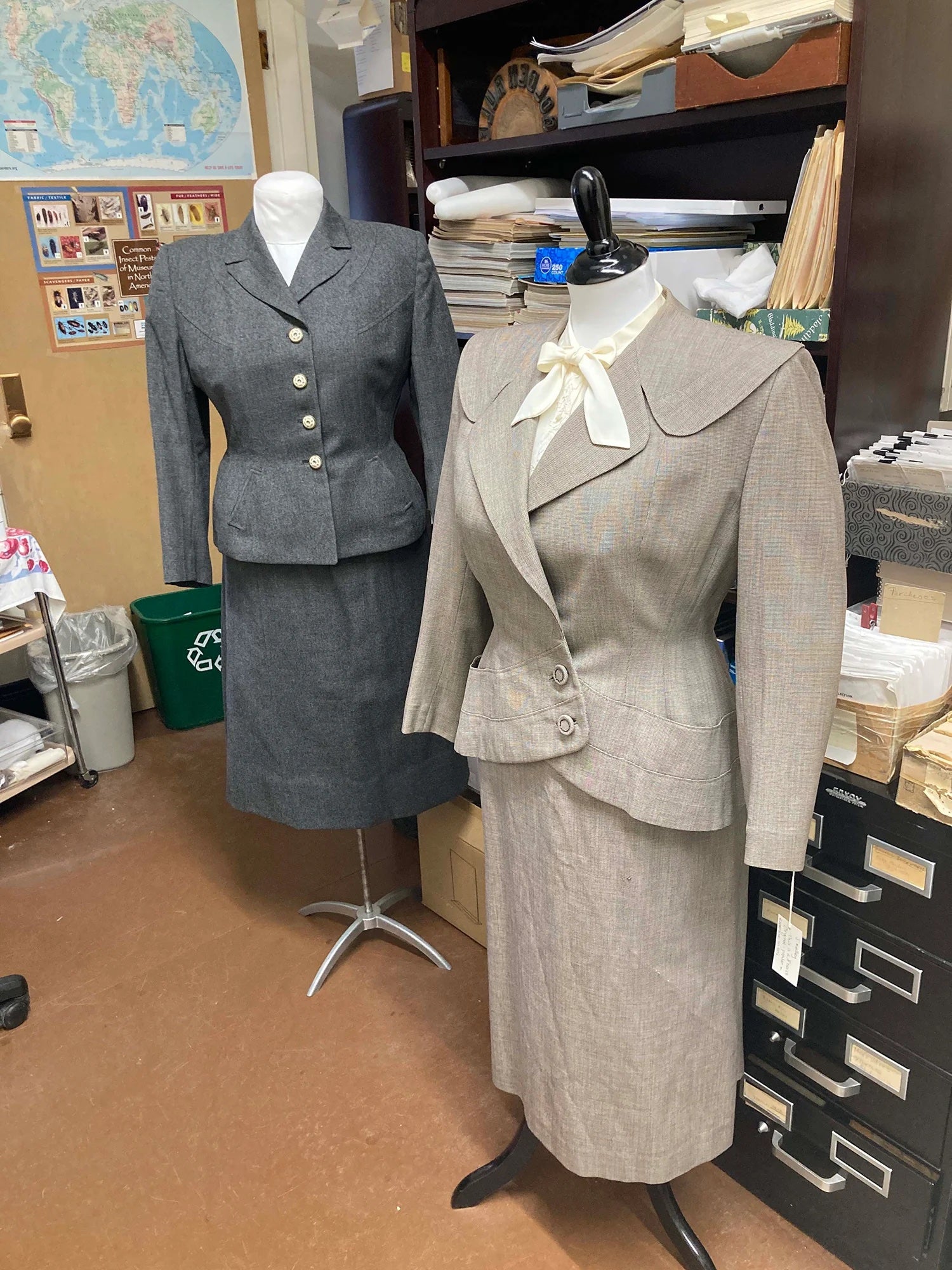 Two women’s suits – from the 1950s (left) and about 1947 – show the influence of the military on style of the time.