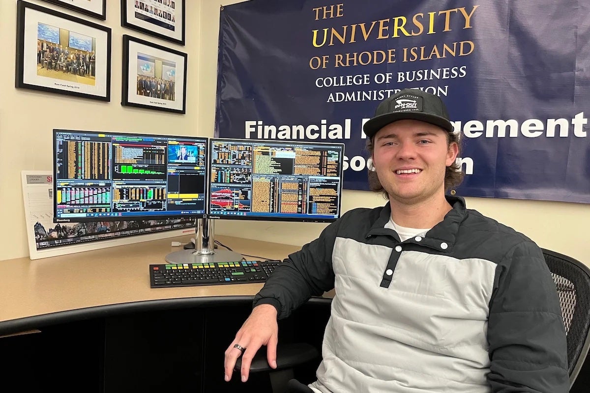 Thomas Buckanavage, a senior finance major, sits at the Bloomberg computer in the Sherman Trading Room in URI’s Ballentine Hall. (URI Photo/Tony LaRoche)