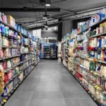 consumer aisle with products on multiple shelves.