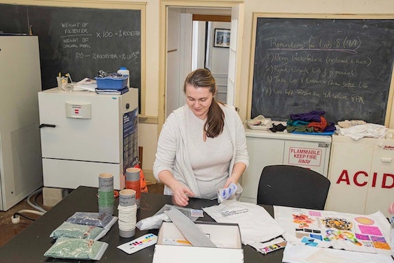URI Textiles faculty member working with textiles