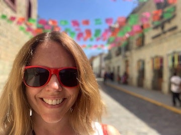 face of a woman wearing red sunglasses