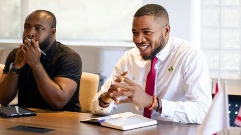 two professionals sit in on a class