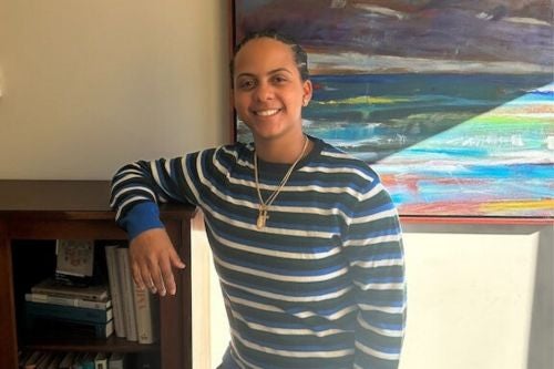 Chantel Rosario smiles in front of colorful art