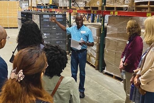 a group of students shadow an Ocean State Job Lot professional at his job