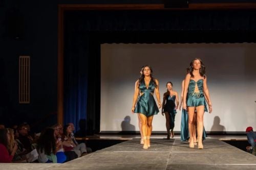 students walking at a live fashion show