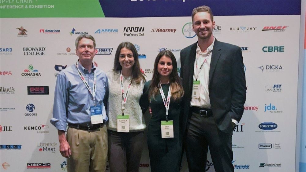 students and a professor at a conference