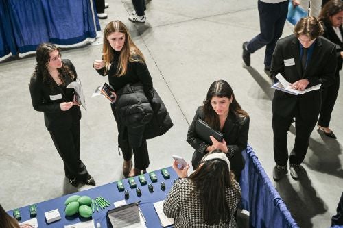 students talk with a recruiter on career day