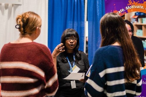 a recruiter speaks to two students