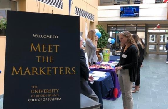 students are greeted at an event table