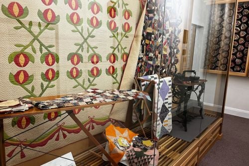 an array of historic quilts on display
