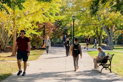 students walking through campus on a sunny day