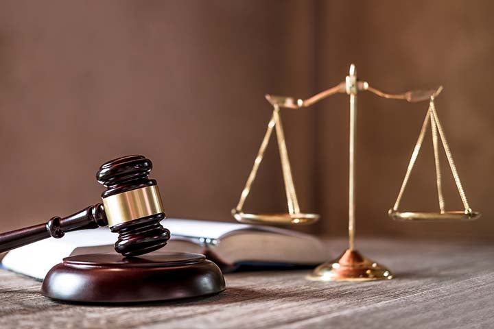 Scales of justice and Gavel on wooden table and agreement in Cou