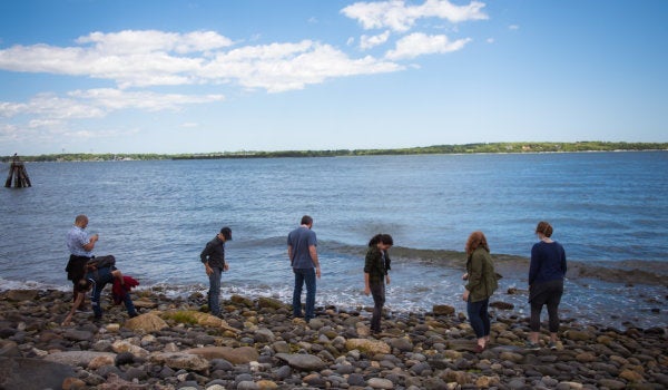Students walking on the beach at the Narragansett Bay Campus
