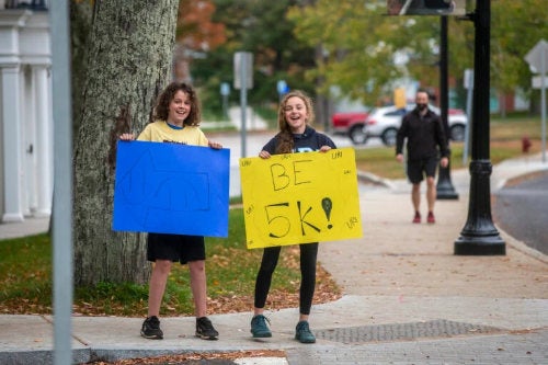 Students hold signs at this year’s Be 5K which raised over $3,300 for the Heather Fund