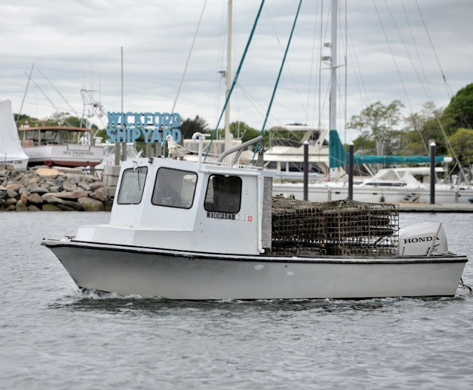 Image of a white fishing boat in the water