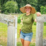 Cassidy Need ’20, owner of sustainable gardening company Native Edible Designs, is standing in a client’s garden.