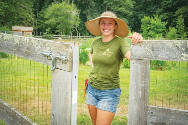 Cassidy Need ’20, owner of sustainable gardening company Native Edible Designs, is standing in a client’s garden.