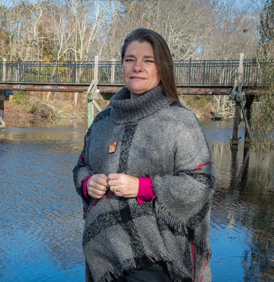 Elisabeth Herron stands next to a waterway in Wakefield, RI. As the program coordinator for the URI Watershed Watch program, Rhode Island’s largest volunteer water quality monitoring program, she is actively involved in assessing water quality and watershed conditions throughout the state, including lakes, ponds, streams, salt ponds and marine beaches. 