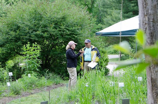 David Vissoe, URI Master Gardener and liaison to the U.S. Fish and Wildlife Kettle Pond Nature Center Native Plant Gardens, talks to a visitor during an open house.