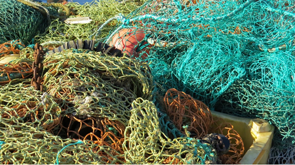 image of a jumbled tangle of different color fishing nets