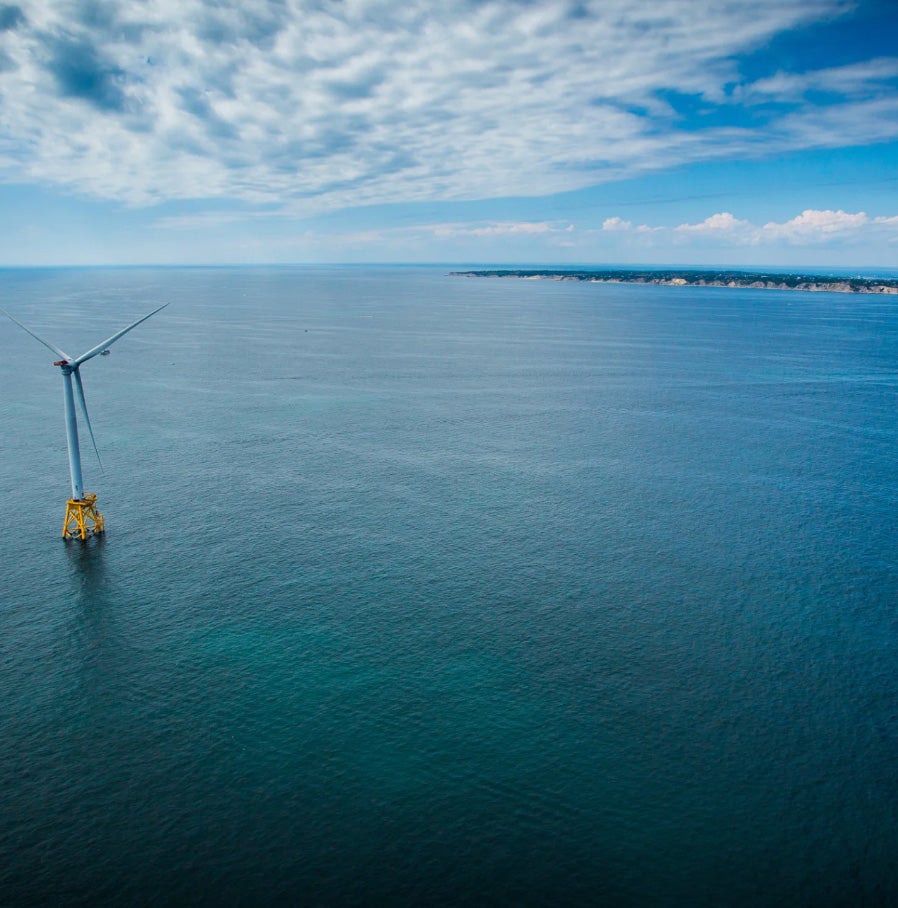 image of the ocean with a wind turbine to the left of the center view