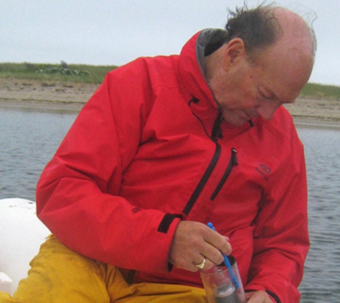 Westerly's Grant G. Simmons III takes a sample at Napatree Point. Photo courtesy of the Henry L. Ferguson Museum.