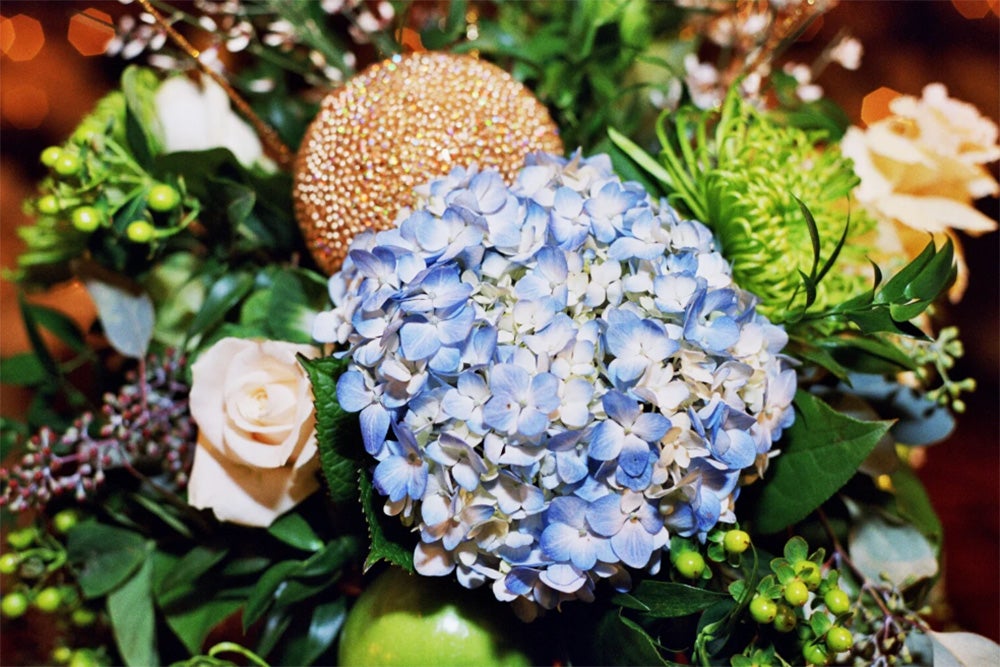 image of a bouquet of hydrangea, roses, and other greenery