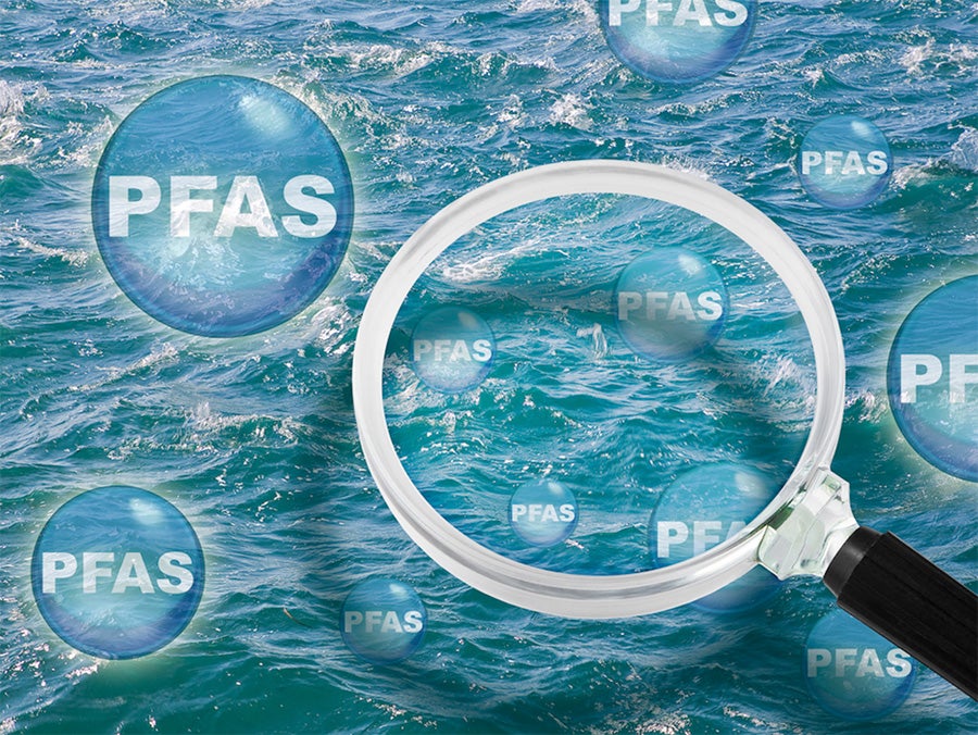 image of a magnifying glass over water with bubbles with "PFAS" written on them