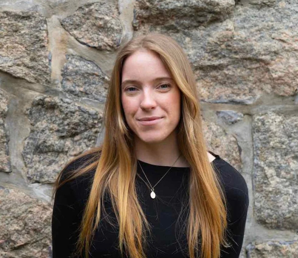 image of CELS Landscape Architecture Maria Potvin smiling in front of a stone wall