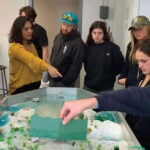 Students in the honors course River Stories visited URI geoscientist Soni Pradhanang’s river simulation table.