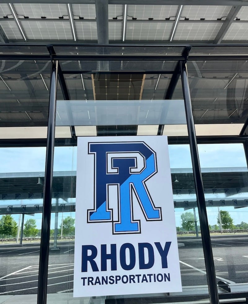 image of a sign at a parking lot with the URI logo and the text, "Rhody Transportation"