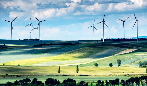 An expansive landscape with win turbines in the background