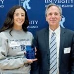 URI alumna Alexandra Winnes holds her 10 Under 10 Award while standing next to Patrick Vivier, dean of the URI College of Health Sciences. (URI Foundation & Alumni Engagement photos)