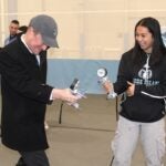 URI President Marc Parlange challenges a kinesiology student to a grip strength test during Biomechanics Day 2025.