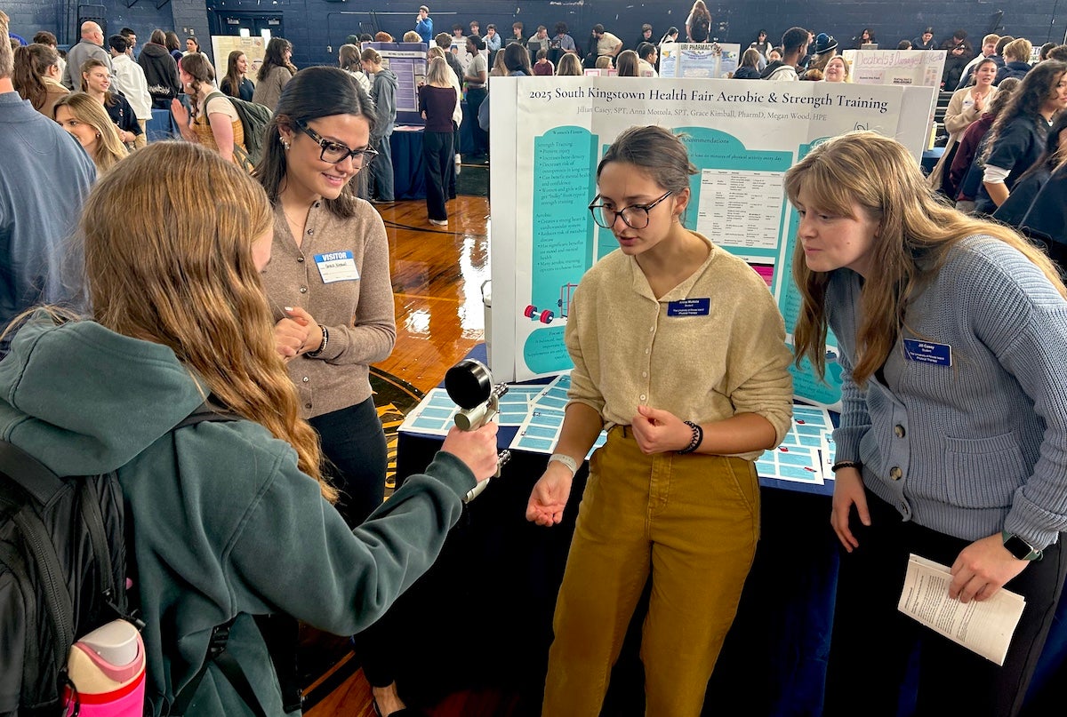 URI students Grace Kimball, Anna Mottola, and Jill Casey test the grip strength of South Kingstown High School students during an interactive health and wellness fair at the high school on Dec. 5.
